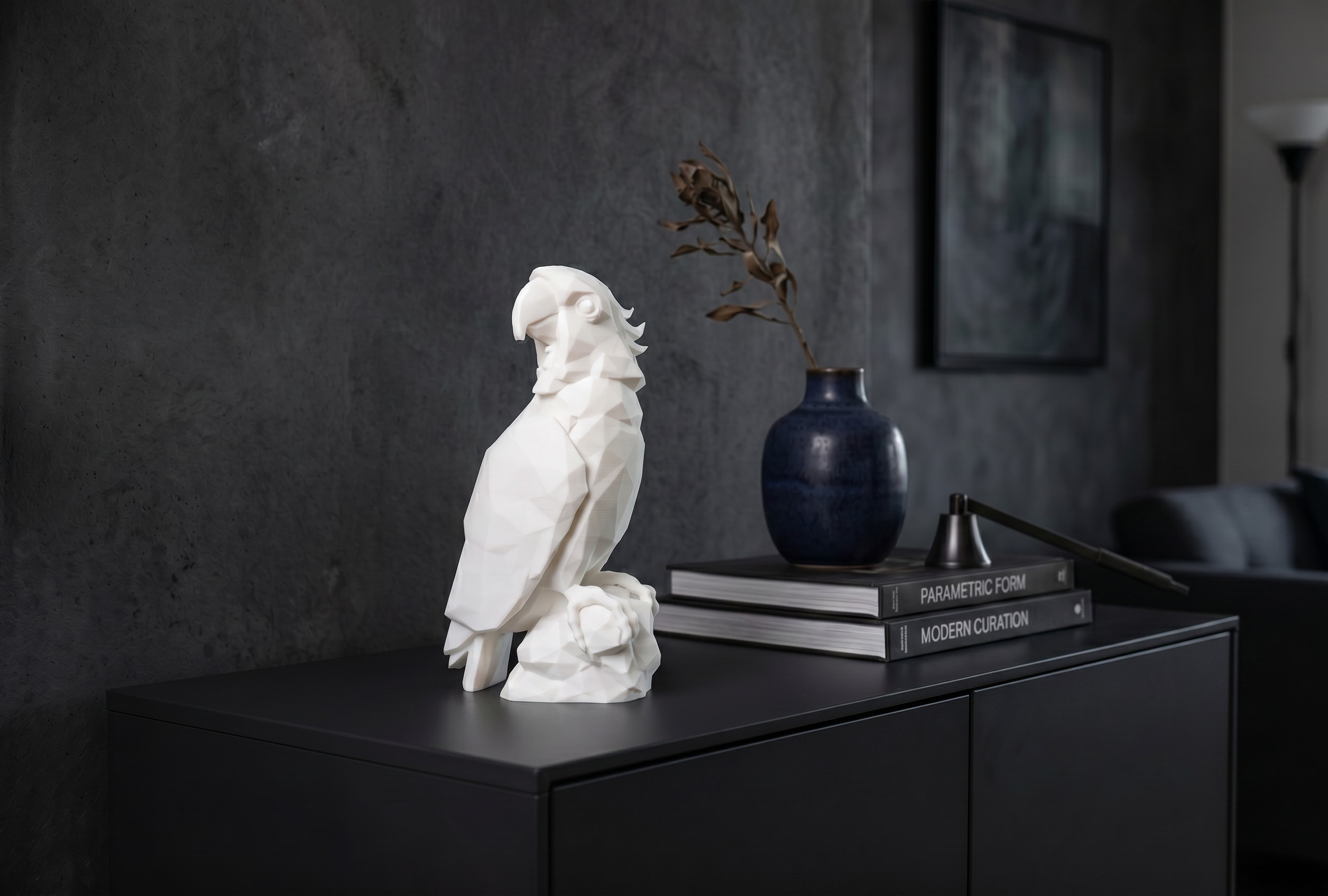 Low-poly parrot sculpture perched on a rock, 3D printed